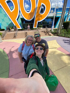 The Research Team taking a selfie in front of the Pop Century sign